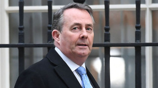 UK to sign Swiss trade deal as heat grows on Liam Fox