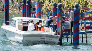 PICTURE EXCLUSIVE: Amal Clooney, 43, stuns in a vibrant orange jumpsuit as she and husband George, 60, take twins Ella and Alexander, 4, to lunch by boat in Lake Como